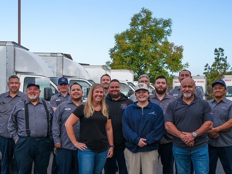 The Hack's Plumbing and Drain crew in front of the fleet