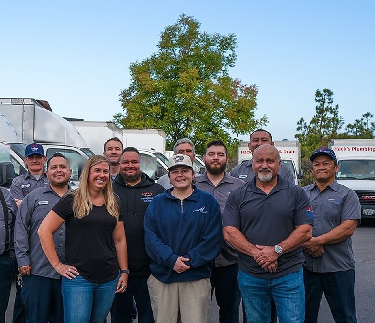 The Hack's Plumbing & Drain crew in front of the fleet