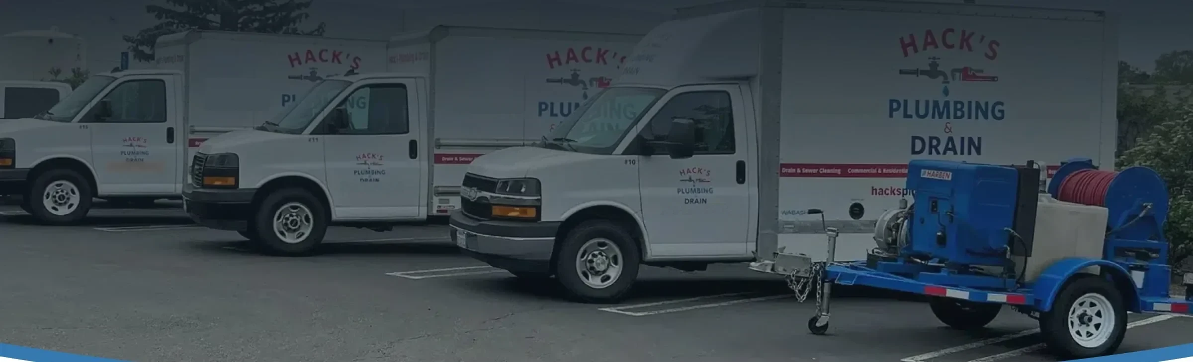 Hack's Plumbing & Drain service vans and hydro jetting trailer