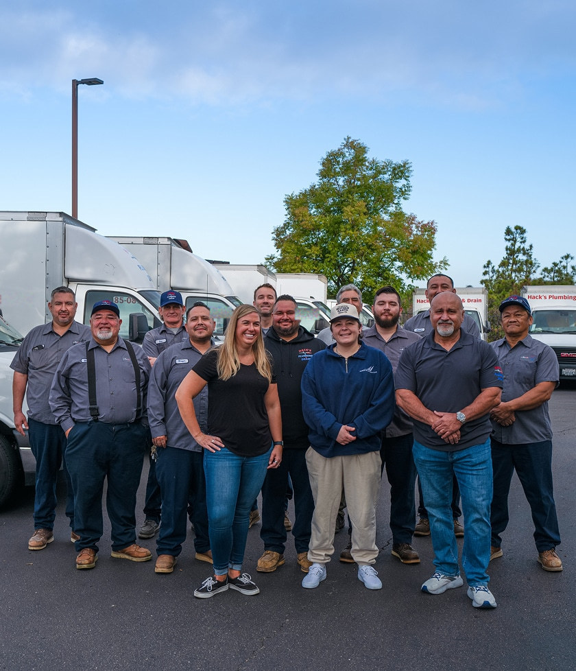 The Hack's Plumbing & Drain team in front of their service vans