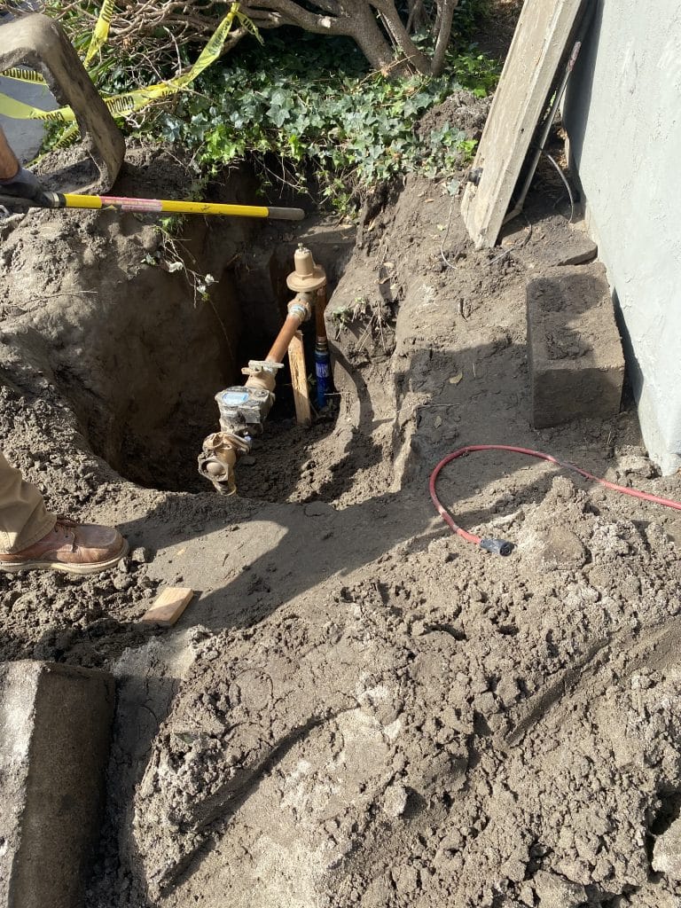 Water main exposed in the trench for repair