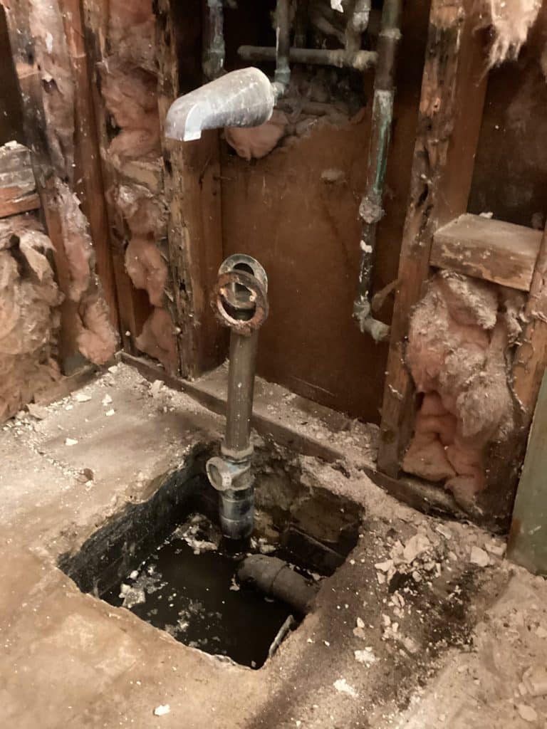 Wall opened behind the tub to reach the valve and drain