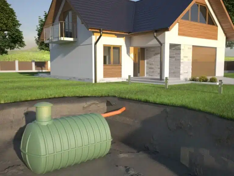 Septic tank set in an excavation in front of a house
