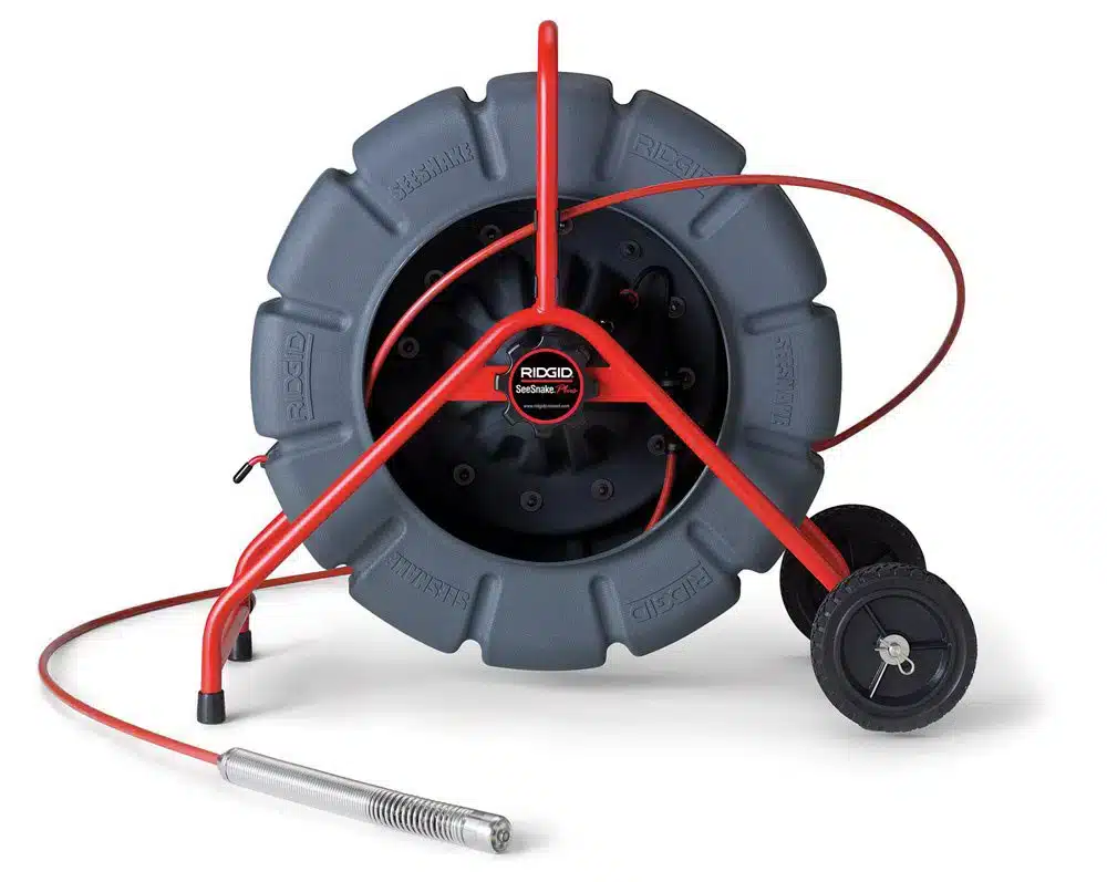Sewer inspection camera cable on a red wheeled reel