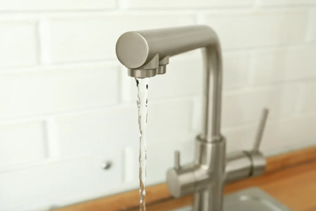 Kitchen faucet running water showing plumbing system in a San Diego home